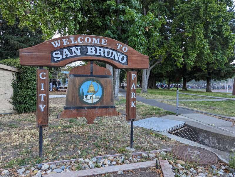 Bell-shaped sign with city logo