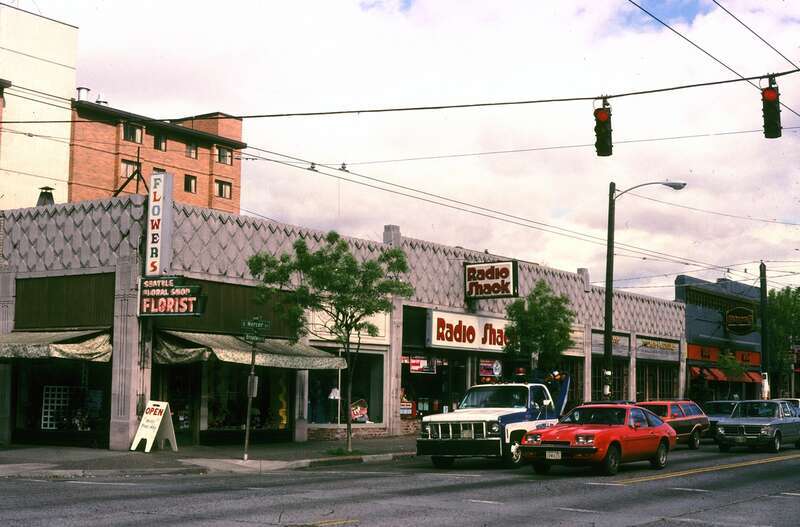 Broadway, Seattle, Washington, U.S. at Mercer St., circa 1980. Florist on corner, Radio Shack at center.
