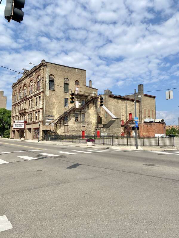 Built in 1890, this Richardsonian Romanesque Revival-style building was designed by Samuel Hannaford for Paul J. Sorg to serve as an opera house.  The building features a brick exterior with a rough-hewn stone front facade, arched window bays on the