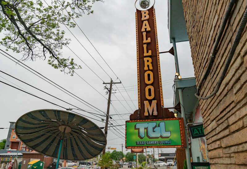 The Texas Gamers Lounge at 29th &amp;amp; Fruth Street in Austin, Texas. TGL is an arcade near the University of Texas at Austin (UT Austin) campus. Outside the building is a &quot;ballroom&quot; sign and a patio seating area.