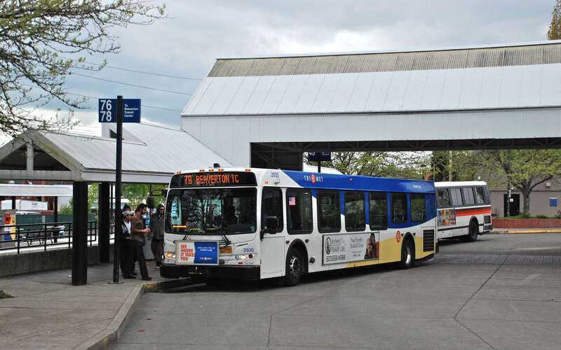 TriMet's Tigard Transit Center, in Tigard, Oregon, with a bus (No. 2935, a 2009 New Flyer D40LFR) loading on line 78, bound for Beaverton TC.  The transit center opened in 1988.  A commuter-rail station was opened adjacent in 2009, for TriMet's