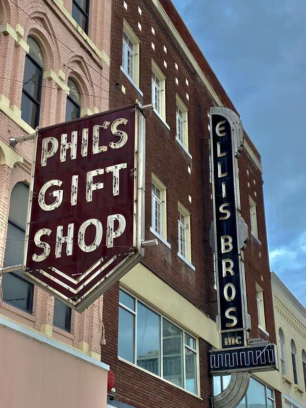 Vintage-styled blade signs from the early and mid-20th centuries adorn the buildings on the pedestrianized northernmost block of Washington Street in downtown Binghamton, New York, as seen in July 2022. These and the surrounding buildings make up
