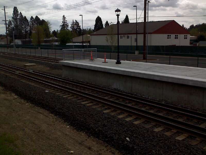 Westside Express Service commuter rail platform next to Tigard Transit Center.  Note the gauntlet track that allows passenger trains to get close to the platform while allowing good clearance for freight trains.