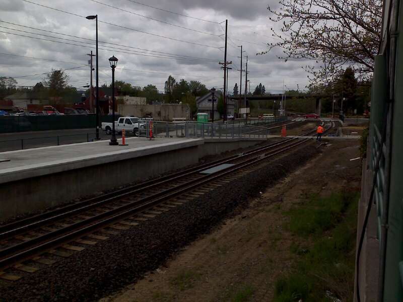 Westside Express Service commuter rail platform next to Tigard Transit Center.  Note the gauntlet track that allows passenger trains to get close to the platform while allowing good clearance for freight trains.