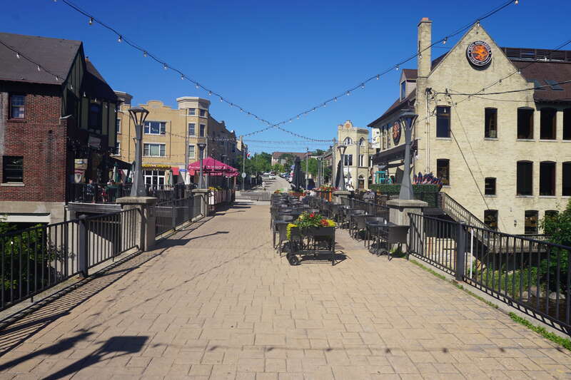 A pedestrian bridge and the Buckatabon and Café Hollander patio in Wauwatosa, Wisconsin (United States).