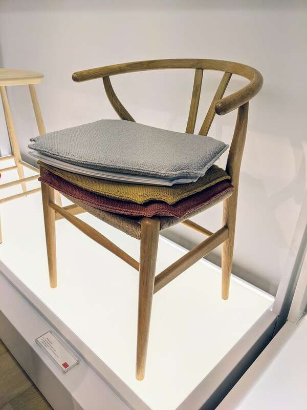 Hans J. Wegner's Wishbone Chair with accessory seat covers on display at Design Within Reach