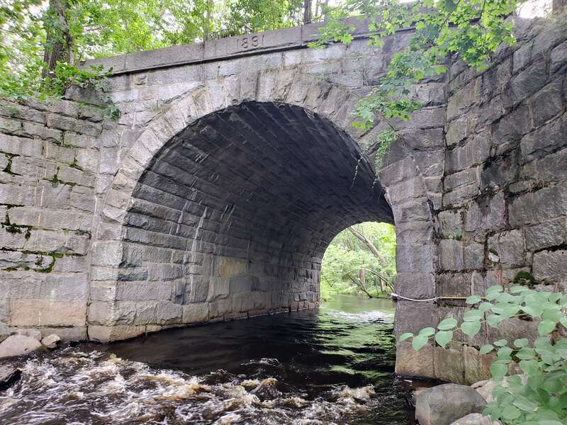 A 1891-built arch bridge that carries the Wrentham Branch over the Neponset River in Norwood, seen  in July 2021
