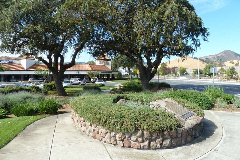 Bronze interpretive plaques and oak trees at site of 21-Mile House, at intersection of Monterey Street and Tennant Avenue in Morgan Hill, Santa Clara County, California, U.S.A.  California Registered Historic Landmark No. 259.  View in westerly