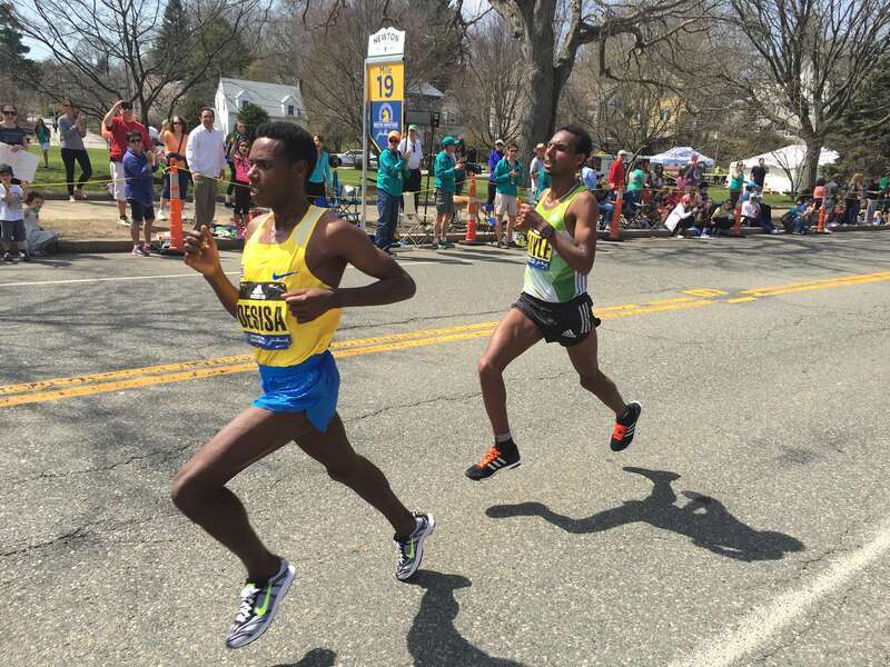 w:Lelisa Desisa leads w:Lemi Berhanu Hayle as they are the first men to pass mile 19 in Newton, Massachusetts during the w:2016 Boston Marathon. Hayle went on to win the elite men's division; Desisa came in second.