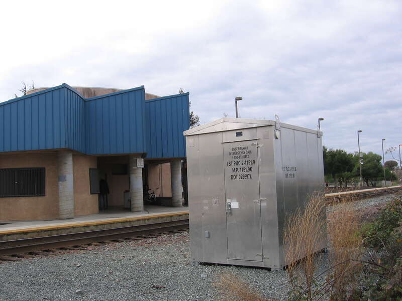 The Antioch–Pittsburg (Amtrak station) in Antioch, California, USA. View is looking southwest from the Riverview sidewalk.  Note the BNSF stencil on the signal box - indicating that this was the AT&amp;amp;SF line in the past (the former SP [now UPRR]