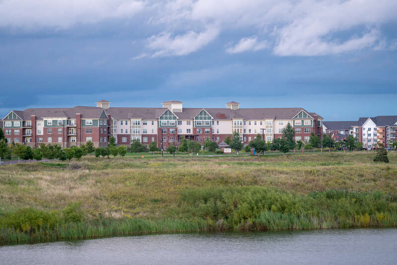 The Bottineau Ridge Apartments and Arbor Lakes Senior Living, as seen from across Arbor Lake near Main Street, Maple Grove, Minnesota.
