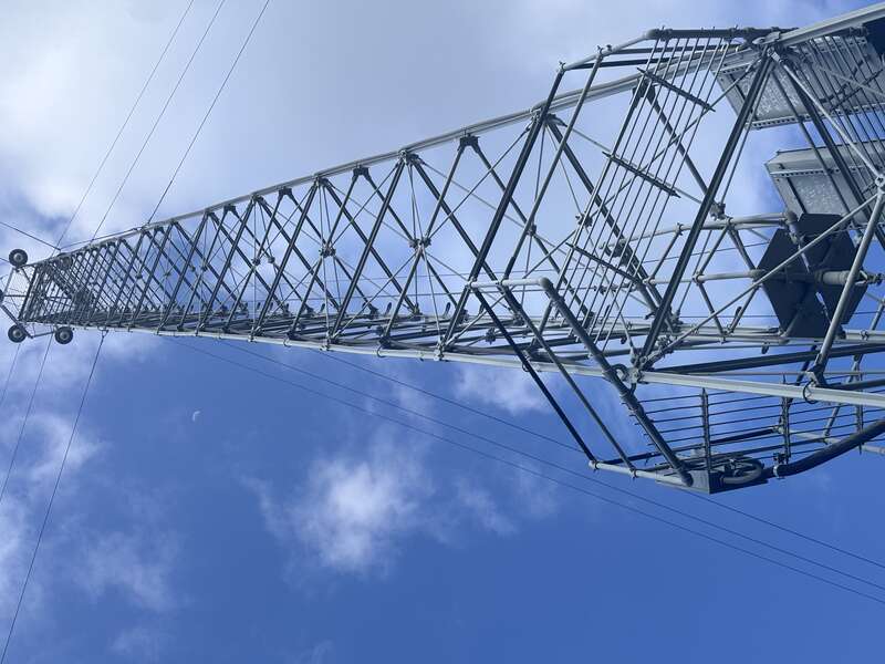 Looking at the top of an Austin, Texas moonlight tower with Earth’s moon in the background. https://en.wikipedia.org/wiki/Moonlight_towers_(Austin,_Texas)