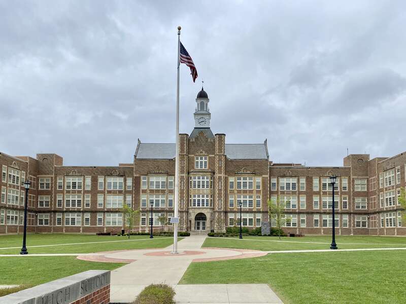 Built in 1926, this Jacobethan Revival-style building was likely designed by Walker and Weeks, and has served as a high school since its construction.  The building was expanded with additions to accommodate increased student enrollment in the