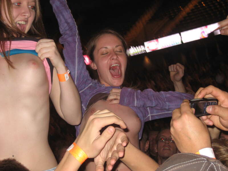 Female fans flashing their breasts at a Godsmack concert in Moline, Illinois on November 5, 2006