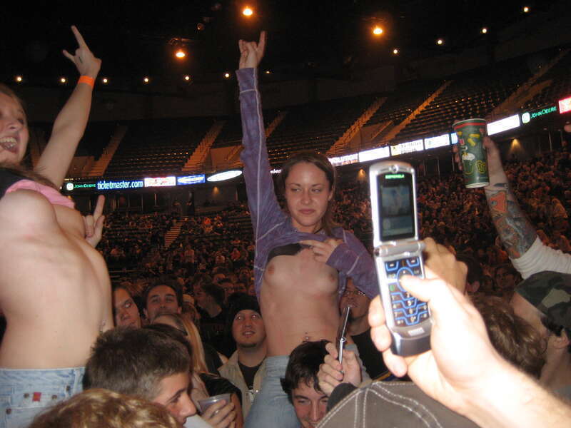 Female fans flashing their breasts at a Godsmack concert in Moline, Illinois on November 5, 2006