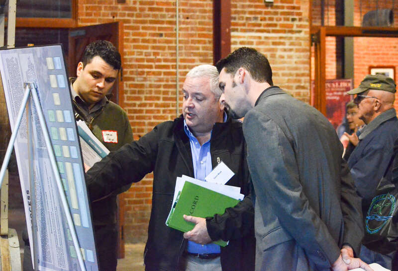 Gene Maak (center), an engineering technical lead with the U.S. Army Corps of Engineers Sacramento District, shows two attendees the area in the Sacramento-San Joaquin Delta the Corps will study as part of the Delta Islands and Levees Feasibility