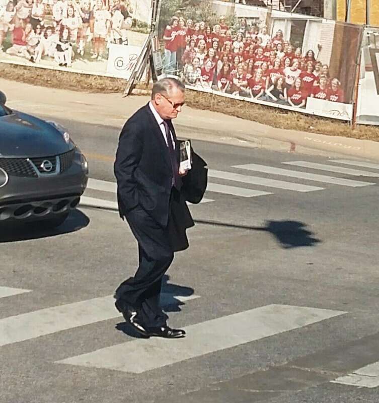 Former University of Arkansas Chancellor G. David Gearhart crosses Maple Street on campus in Fayetteville