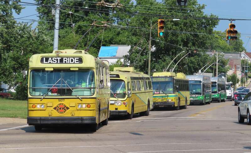 Dayton, Ohio: A line-up of several different types of trolley buses running on a charter, or fan trip, during the 2021 Hoosier Traction Meet, shown here westbound on Wyoming Street at Wayne Avenue, on the Dayton, Ohio, trolley bus system.  In the
