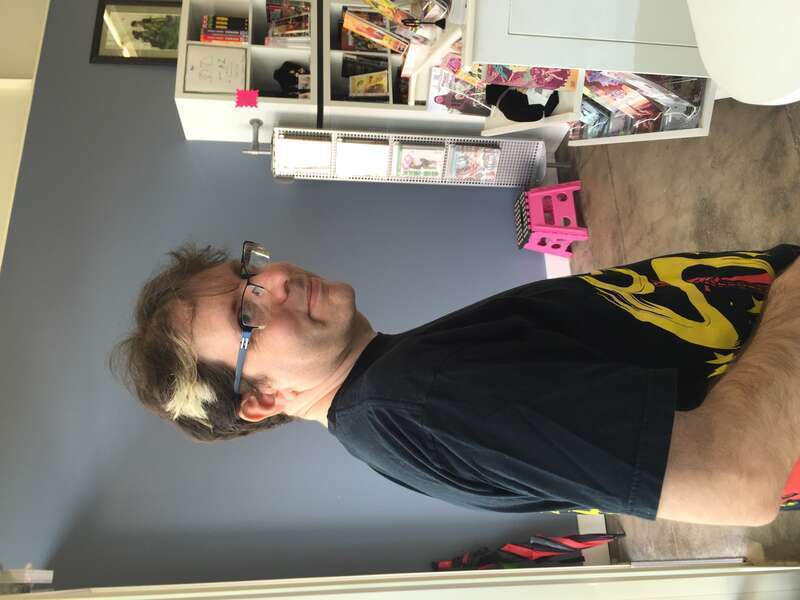 Author and Critic Douglas Wolk standing in a comic shop in Portland, Oregon.