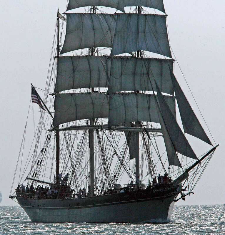 The tall ship Elissa, which has sailed in three centuries, sails up the channel into Port Galveston, Texas.