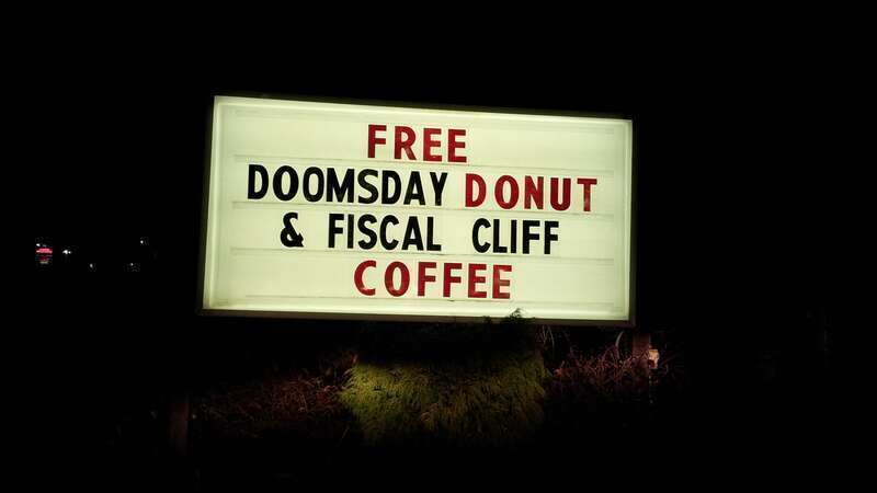 Sign advertising &quot;FREE DOOMSDAY DONUT &amp;amp; FISCAL CLIFF COFFEE&quot; at Petersen's Carpet and Flooring in Frederick, Maryland.

Ben Schumin is a professional photographer who captures the intricacies of daily life.  This image may be used under Creative