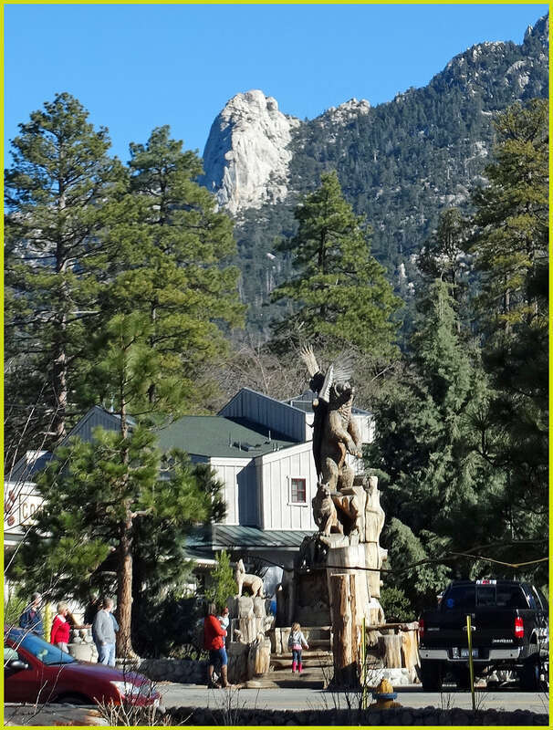 (1 in a multiple picture set)
Two of Idyllwild's landmarks are shown in this picture.  On top is Tahquitz Rock, and at the bottom is the very well done wood sculpture called &quot;Harmony.&quot; It shows all the different species of wildlife in the area living