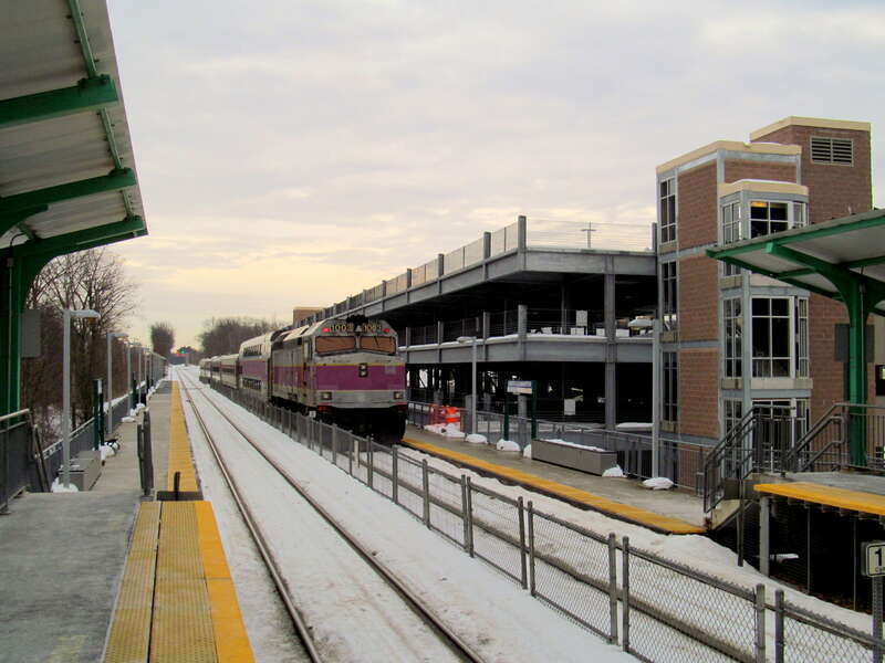 An inbound train leaves North Leominster station in December 2013. The parking garage was nearly finished at this time, but not yet open.