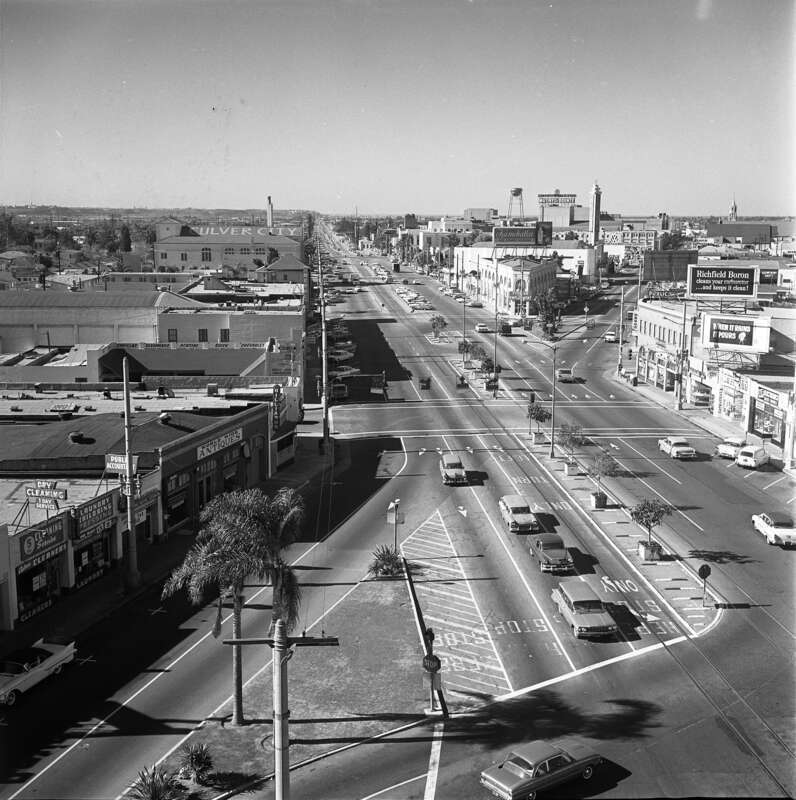 Original caption:  &quot;DOWNTOWN INTERSECTION—Contrasting views of Culver and Washington Blvds., junction looking to the southwest, shows progress of last 40 years.&quot; Culver Blvd. is the main thoroughfare and Washington Blvd. is the smaller one.
