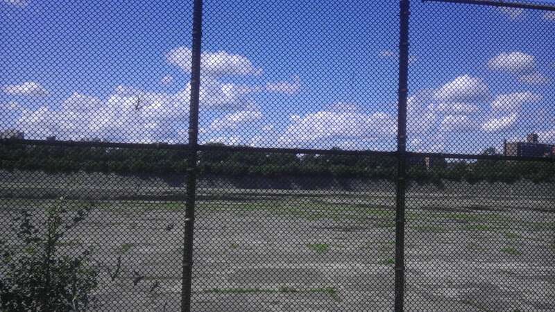Looking northeast at Jerome Park Reservoir, empty.