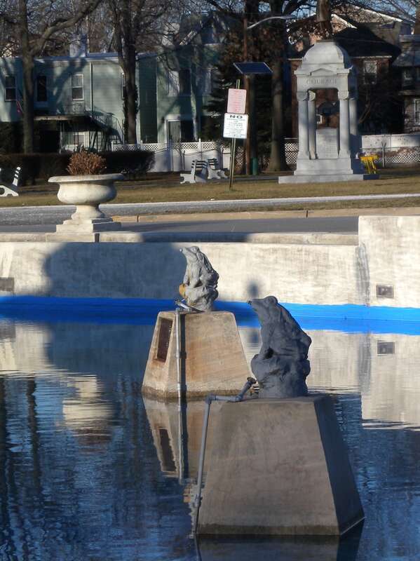 Looking north at stone frogs in the fountain at Lincoln Park, JC on a sunny afternoon.