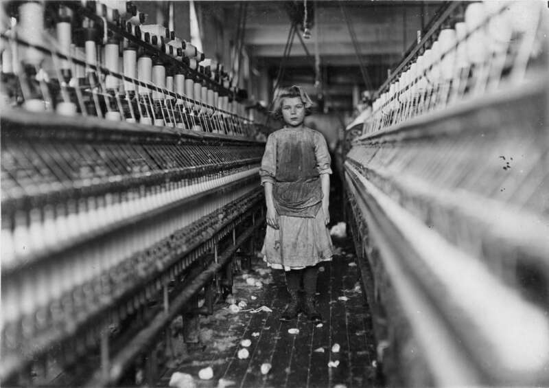 Little spinner in Globe Cotton Mill, Augusta, Georgia. Overseer said she was regularly employed. Location: Augusta, Georgia. Photograph by Lewis Wickes Hine, January 1909.