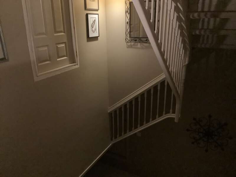 A dark liminal space with stairs that go to nowhere