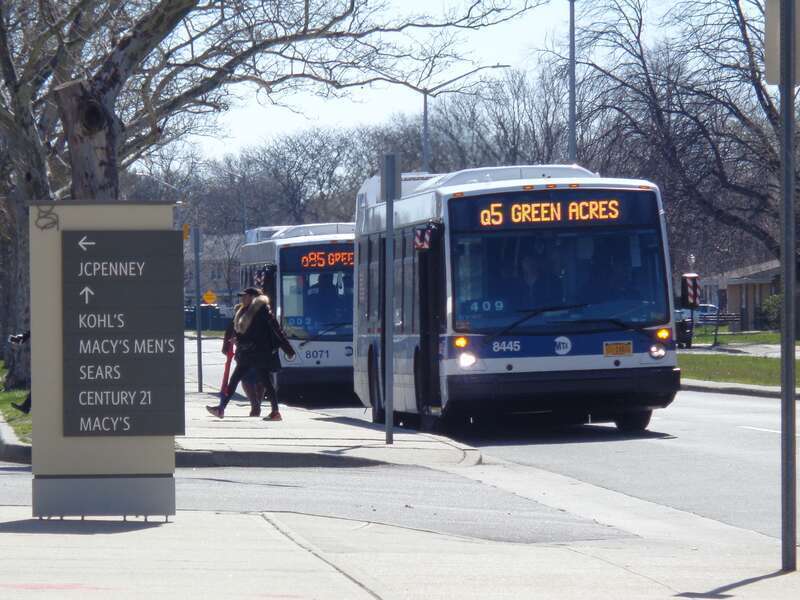 A terminating Q5 bus (front) and a terminated Q85 bus (back) at Green Acres Mall in Valley Stream, Nassau County.