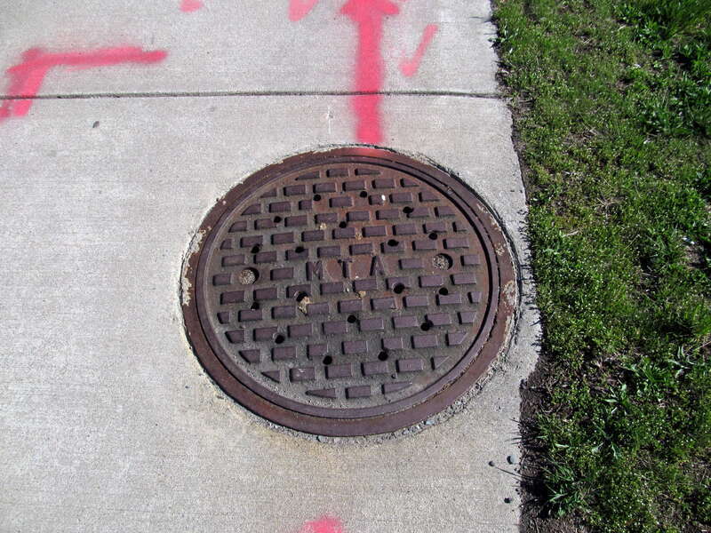 A streethole cover in Everett labeled with M.T.A. (the region's transit agency from 1947 to 1964), seen in April 2017