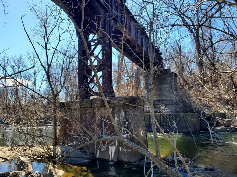 The partially-destroyed Meriden, Waterbury and Connecticut River Railroad bridge over the Naugatuck River, seen in March 2023
