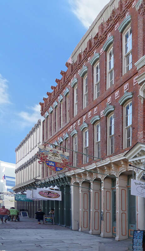 A fire on The Strand in 1869 destroyed an earlier structure at this site. John F. Magale (d. 1880) built this edifice in 1870 to house his wholesale liquor business. Cast iron was used for the first floor facade and window hood molding for the