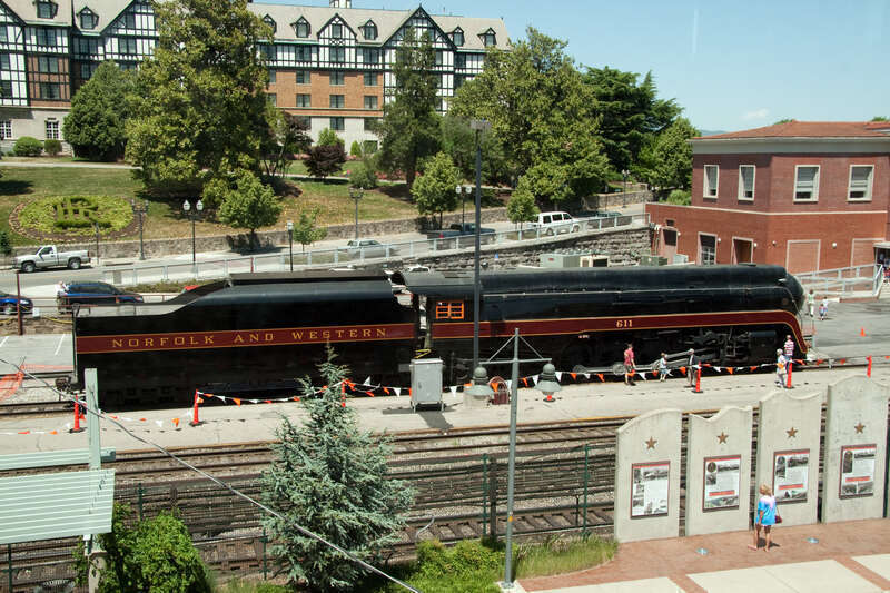 Shot from a pedestrian crossover, N&amp;amp;W 611 sits in front of the Hotel Roanoke (in the background) and the former N&amp;amp;W passenger station (on the right) on National Train Day 2010.
