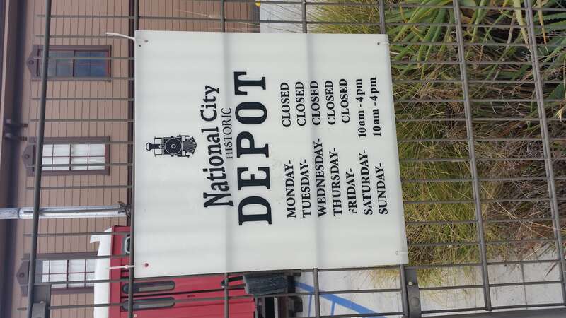A sign informing visitors of the times when the National City Depot is open.