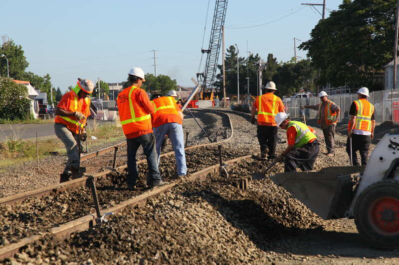 Workers complete final grading of the approach to a new railroad bridge in Napa, Calif., before its official opening in a ceremony June 22, 2011. The U.S. Army Corps of Engineers Sacramento District built the bridge to replace a lower adjacent