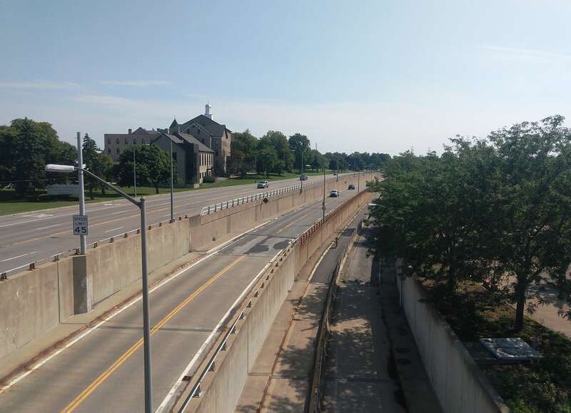 Photo of Niagara Scenic Parkway looking south from the Niagara Power Vista at the Robert Moses Niagara Hydroelectric Power Station in Lewiston, New York. The roadway directly below was formerly the southbound lanes of the parkway (previously named