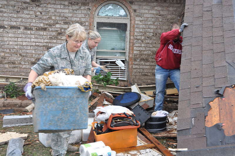 Master Sgt. Cherry Bina, of the Oklahoma Air National Guard's 137th Maintenance Group, recovers personal items from her house that was severely damaged after a devastating tornado hit Moore, Okla. May 20, 2013. (U.S. Air Force photo by Maj. Jon