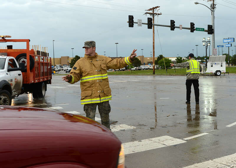 Airman 1st Class Skyler Brooks, 137th Air Refueling Wing firefighter, directs traffic for residents and emergency responders in Moore, Okla., May 20, 2013. (U.S. Air National Guard Photo by Tech. Sgt. Roberta A. Thompson)