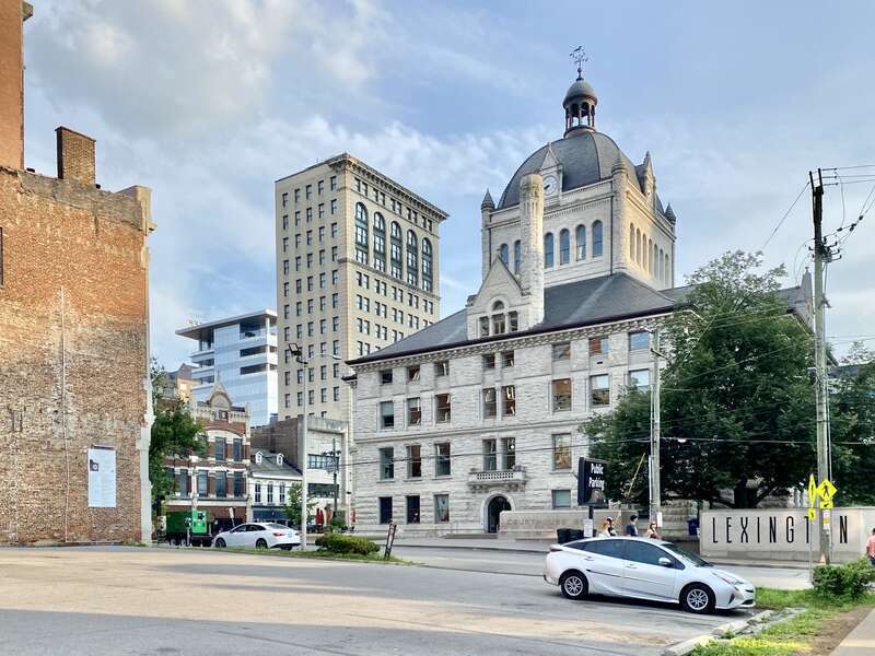 On the left, built in 1898-1900, this Richardsonian Romanesque Revival-style building was designed by Lehman and Schmitt to serve as the Fayette County Courthouse, and is the fifth courthouse to serve Fayette County, replacing a previous courthouse,