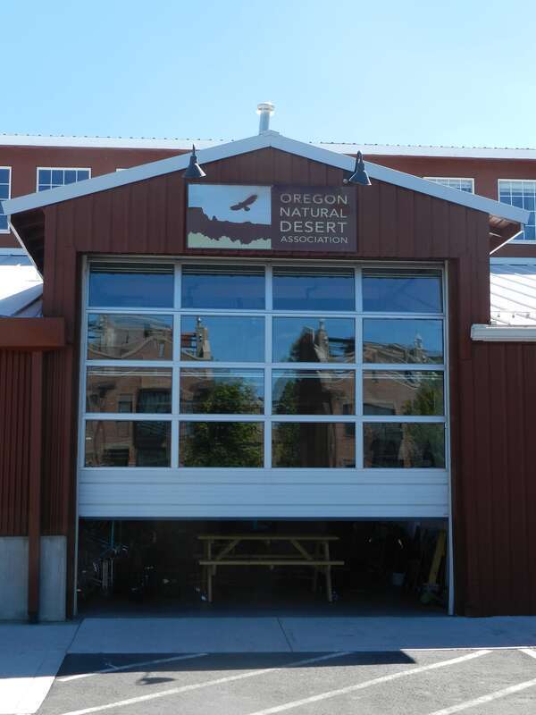 A photo of the signage and garage door of the en:Oregon Natural Desert Association.