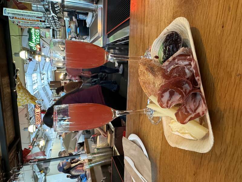 Cheese and charcuterie board with two blood orange mimosas at the Oxbow Cheese &amp;amp; Wine Merchant.