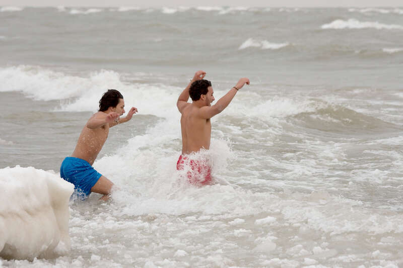 Two men going into Lake Michigan, Polar bear plunge during New Year's Day 2009, Bradford Beach, Milwaukee, Wisconsin