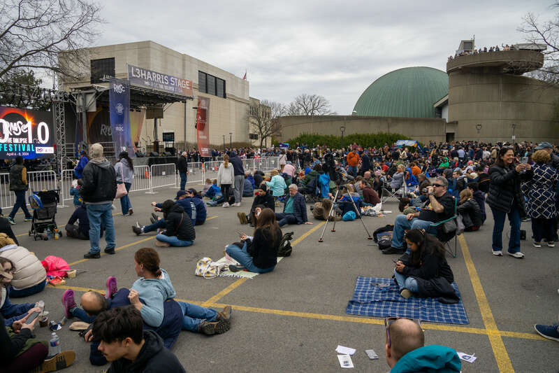 People gather at the ROC the Eclipse 2024 Festival at RMSC, Rochester New York.