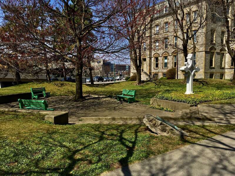 As seen on a sunny afternoon in April 2021, this pleasantly shaded green space on the west side of Franklin Street shares its name with the adjacent Catholic cathedral. St. Joseph's Park was dedicated in 1973 on what was once the site of St.