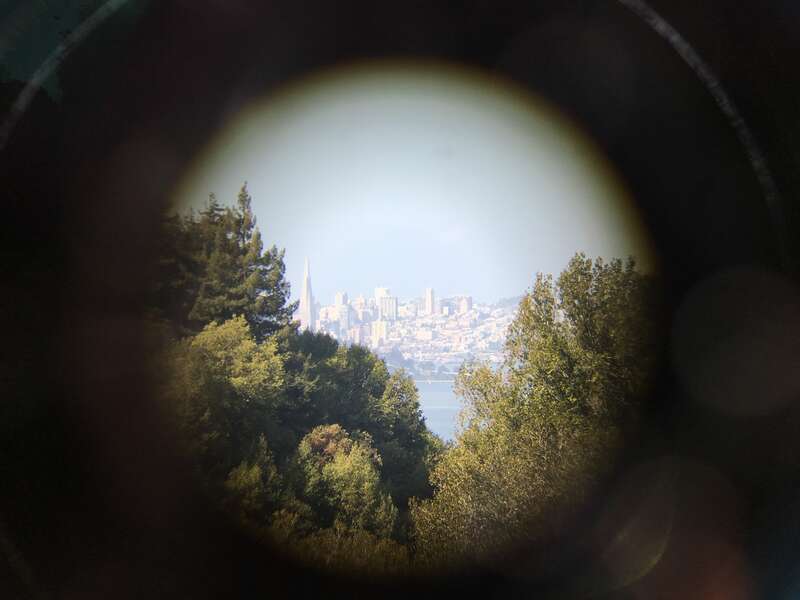 San Francisco as seen through binoculars shot on a cellphone from Berkeley California