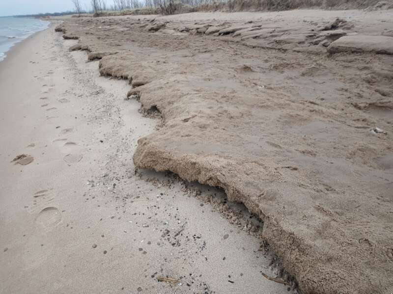A stretch of shelf ice that has been coated with sand by the wind, causing it to remain unmelted even after all exposed shelf ice has disappeared, at Lake Street Beach in Gary, Indiana, at the southernmost tip of Lake Michigan.